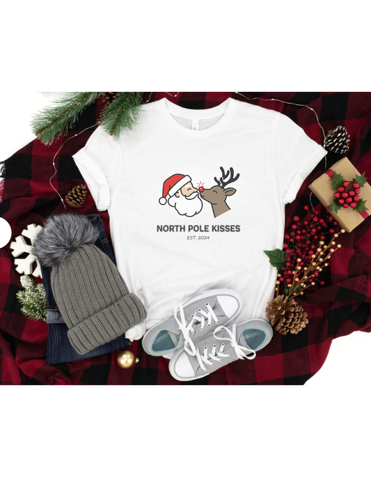 North Pole Kisses Unisex Heavy Cotton Tee, Christmas Tee, Holiday Gift, Festive Apparel, Winter T-Shirt, Santa and Reindeer Design